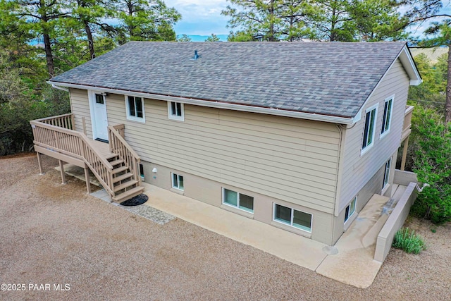 1251 Navajo Way, Prescott, AZ 86305 - back of property featuring a shingled roof, a patio, stairway, and a wooden deck