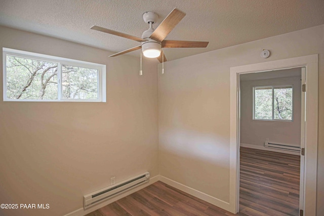 1251 Navajo Way, Prescott, AZ 86305 - spare room with baseboard heating, dark wood finished floors, plenty of natural light, and a textured ceiling