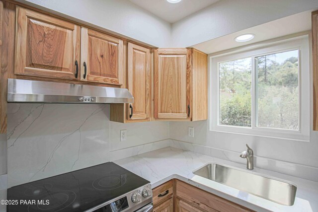 1251 Navajo Way, Prescott, AZ 86305 - kitchen with under cabinet range hood, stainless steel electric range, a sink, and light stone countertops