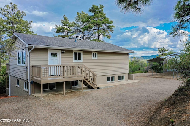 1251 Navajo Way, Prescott, AZ 86305 - back of property featuring a deck, a shingled roof, and stairs