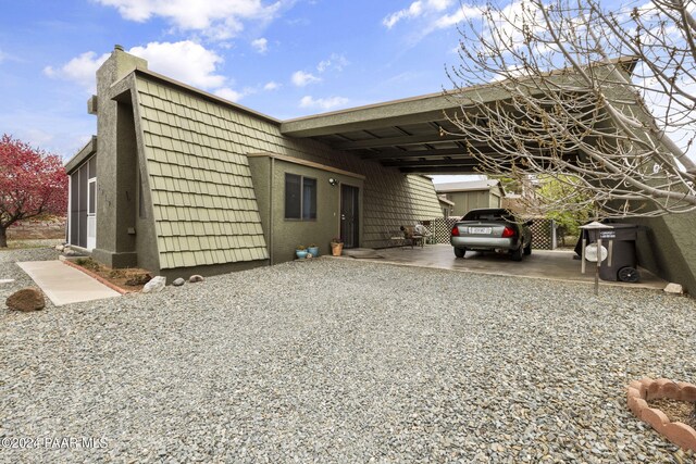 view of side of property with a carport