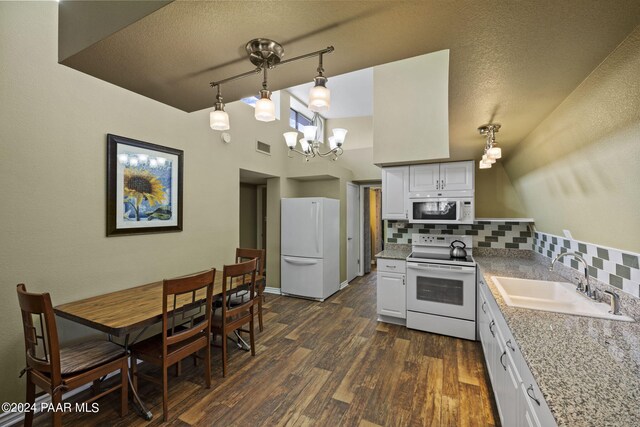 kitchen featuring white cabinetry, sink, backsplash, decorative light fixtures, and white appliances