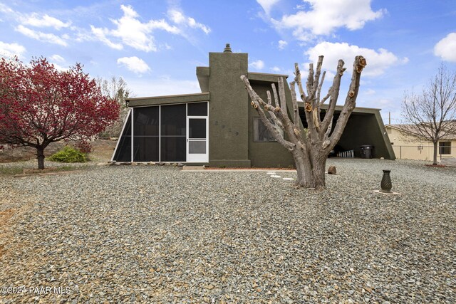 rear view of house featuring a sunroom