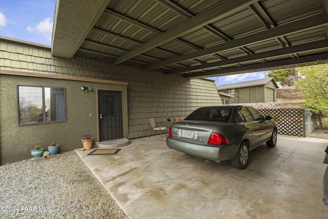 view of exterior entry with a carport