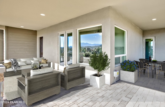 view of patio featuring an outdoor living space and a mountain view