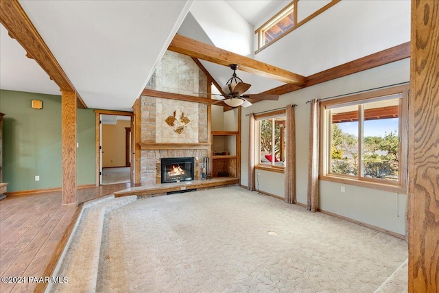 14420 Jagged Tooth Trl, Mayer, AZ 86333 - unfurnished living room with a large fireplace, ceiling fan, wood-type flooring, high vaulted ceiling, and beamed ceiling