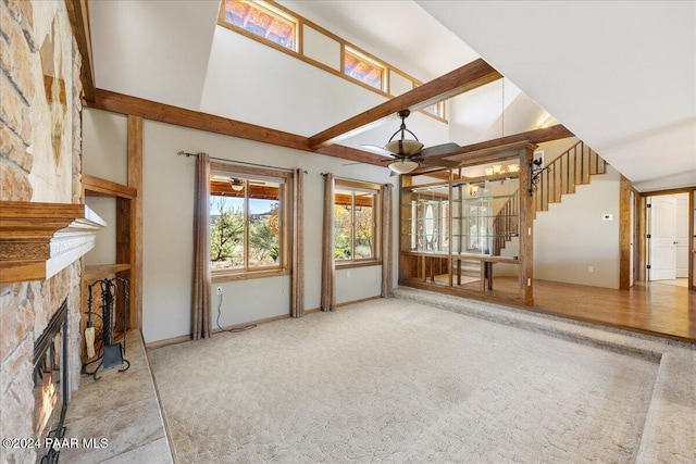 14420 Jagged Tooth Trl, Mayer, AZ 86333 - unfurnished living room with a fireplace, vaulted ceiling with beams, carpet floors, and ceiling fan