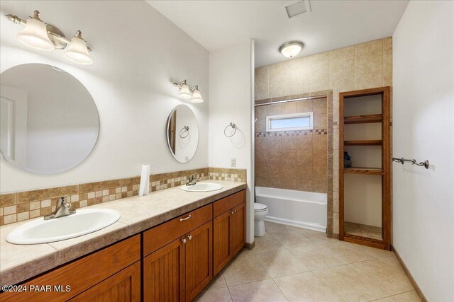 14420 Jagged Tooth Trl, Mayer, AZ 86333 - full bathroom featuring double vanity, tile patterned flooring, shower / bath combination, and backsplash