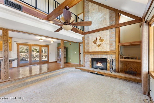 14420 Jagged Tooth Trl, Mayer, AZ 86333 - unfurnished living room featuring ceiling fan, a fireplace, high vaulted ceiling, and wood-type flooring