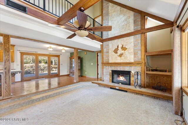 14420 Jagged Tooth Trl, Mayer, AZ 86333 - unfurnished living room with high vaulted ceiling, a stone fireplace, and ceiling fan