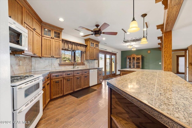 14420 Jagged Tooth Trl, Mayer, AZ 86333 - kitchen with backsplash, white appliances, ceiling fan, wood-type flooring, and decorative light fixtures