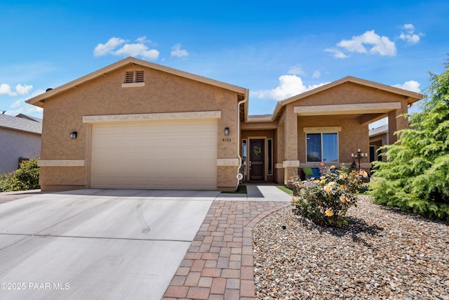 ranch-style house with a garage, stucco siding, and driveway