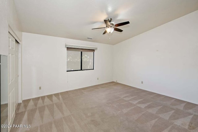 empty room with light carpet and ceiling fan