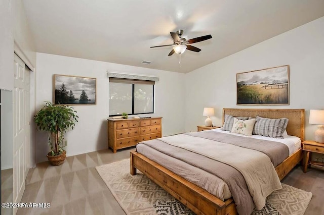 bedroom featuring ceiling fan, a closet, and vaulted ceiling