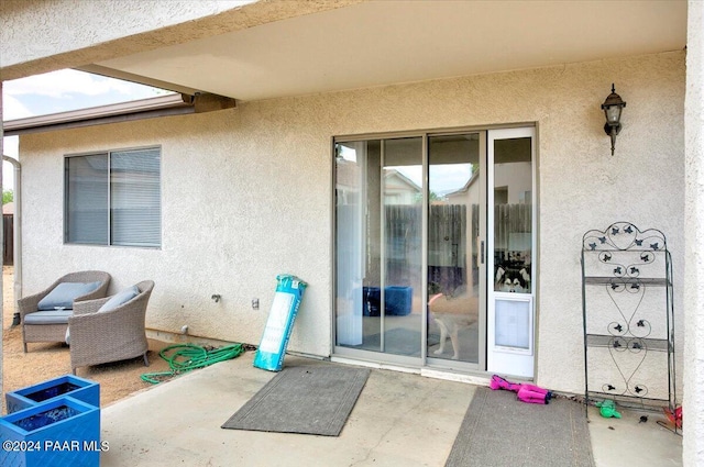 doorway to property with a patio area