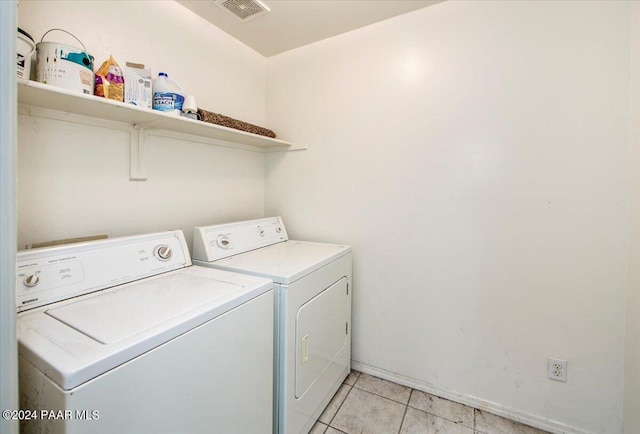 washroom featuring light tile patterned flooring and washing machine and dryer