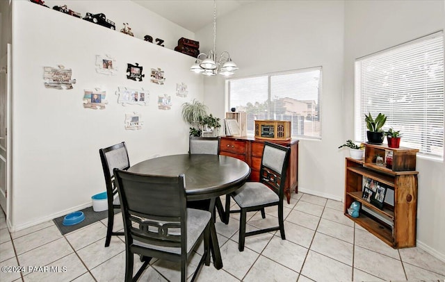 tiled dining area with an inviting chandelier and vaulted ceiling