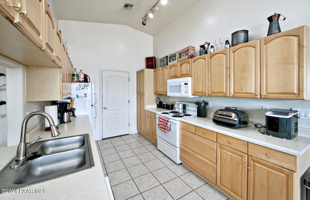 kitchen with vaulted ceiling, light tile patterned flooring, sink, light brown cabinets, and white appliances