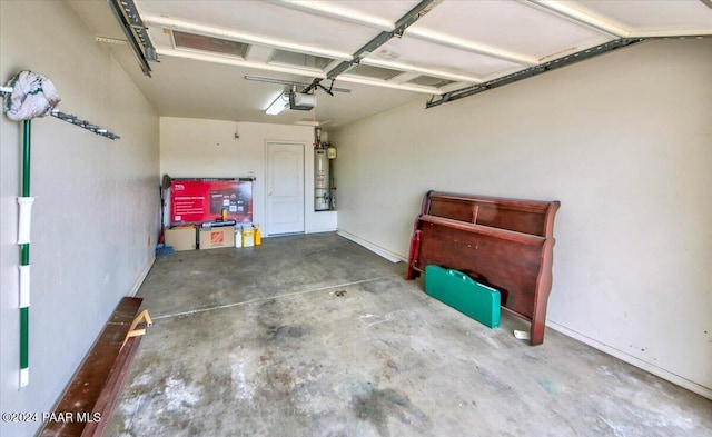 garage with a garage door opener and water heater