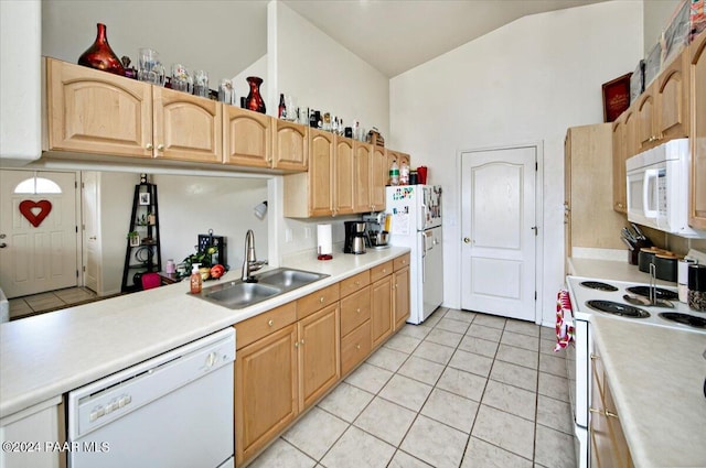 kitchen featuring lofted ceiling, sink, white appliances, light tile patterned flooring, and light brown cabinets