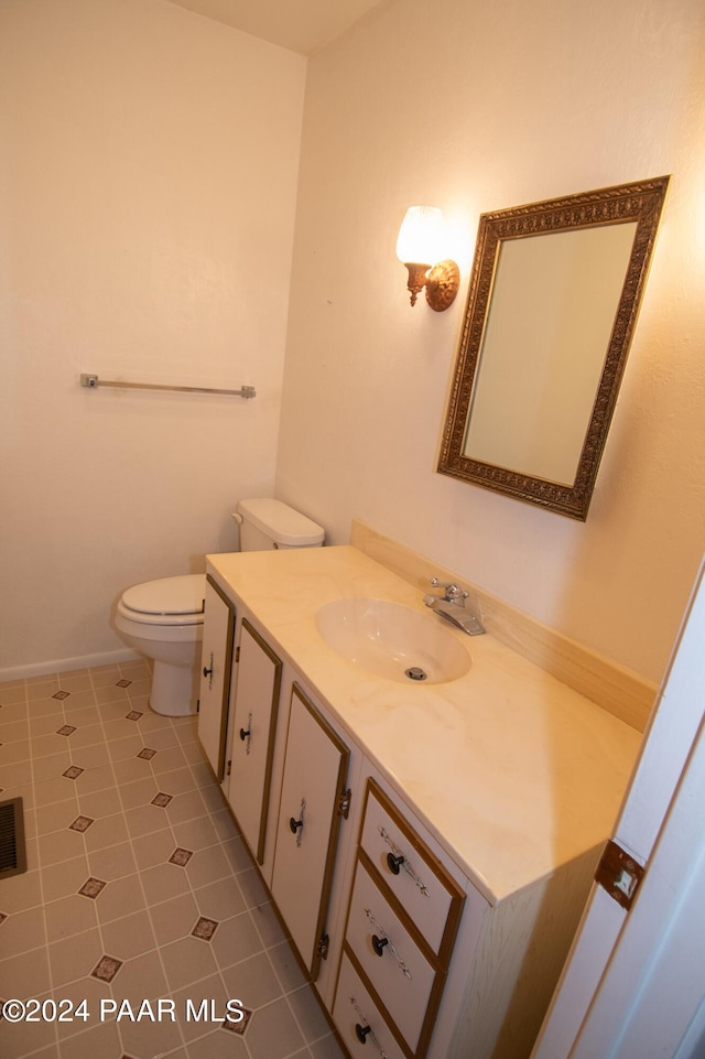 bathroom featuring toilet, vanity, and tile patterned floors