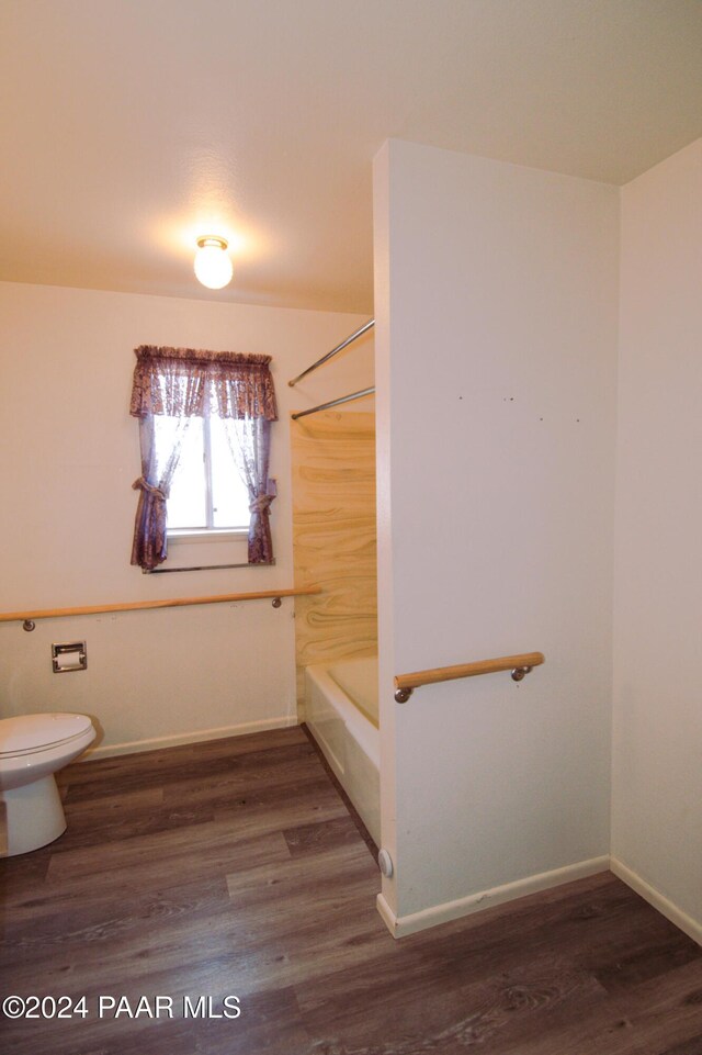 bathroom with shower / bath combination, wood-type flooring, and toilet