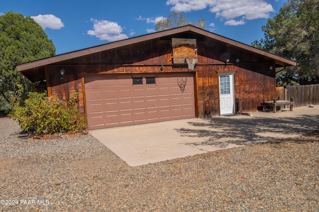 view of property exterior featuring a garage and an outdoor structure