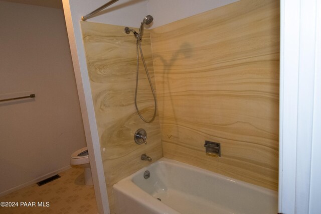 bathroom with shower / bathing tub combination and toilet