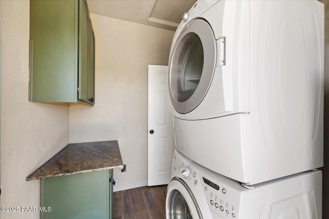17940 E Native Dancer Ln, Dewey-Humboldt, AZ 86327 - laundry area featuring stacked washing machine and dryer, cabinet space, and dark wood-style flooring