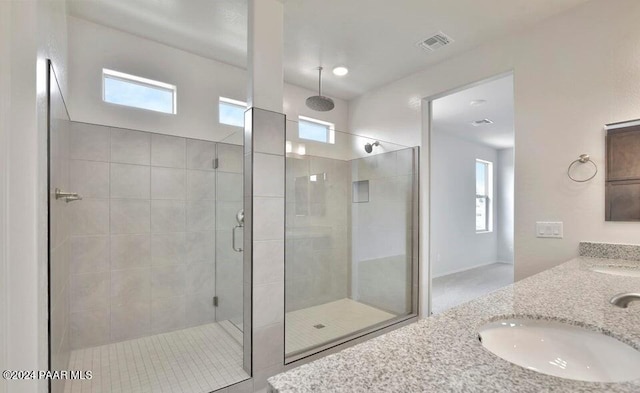 bathroom featuring vanity and a shower with door