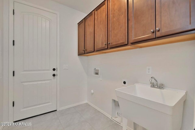 laundry area featuring sink, cabinets, washer hookup, electric dryer hookup, and light tile patterned flooring