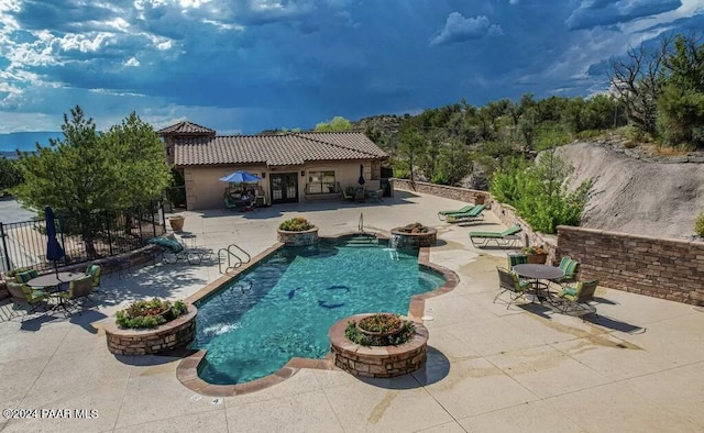 view of pool featuring pool water feature and a patio area