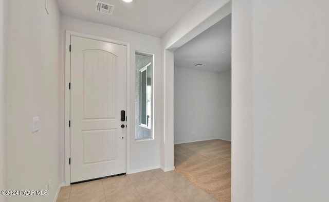 foyer featuring light carpet