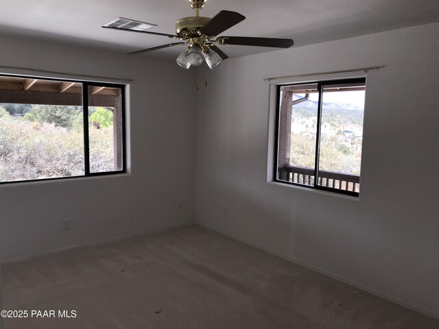 18700 S Aggie Hodge Rd, Peeples Valley, AZ 86332 - spare room with baseboards, a ceiling fan, and visible vents