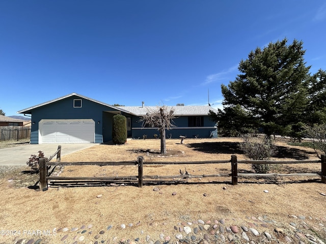 single story home with fence, an attached garage, and concrete driveway