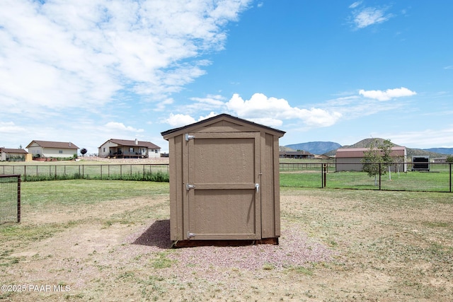 view of outdoor structure featuring a lawn and a mountain view