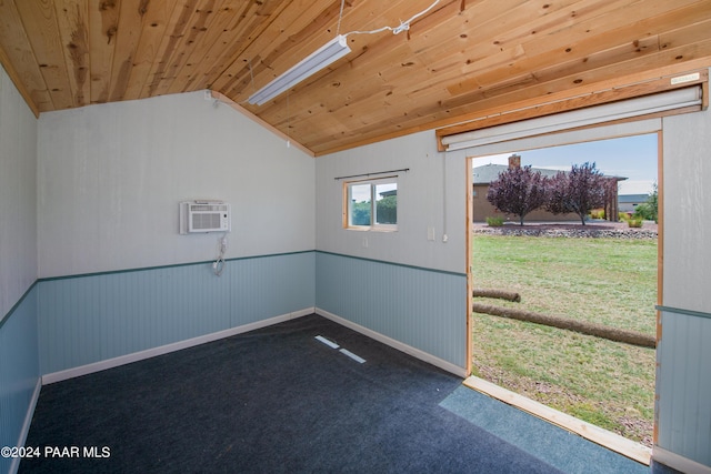 carpeted spare room featuring wooden ceiling, a wall mounted AC, and lofted ceiling