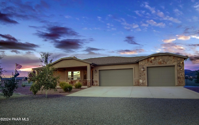 view of front of home featuring covered porch and a garage