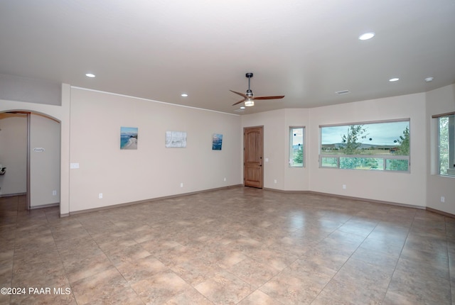 unfurnished living room featuring ceiling fan