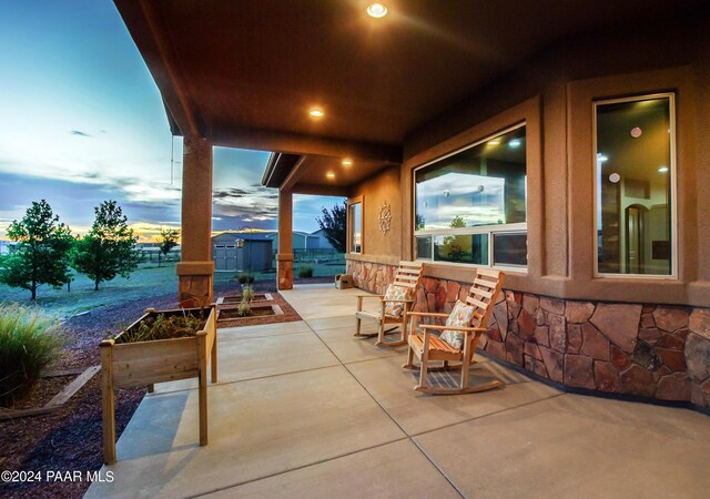 patio terrace at dusk with a storage shed