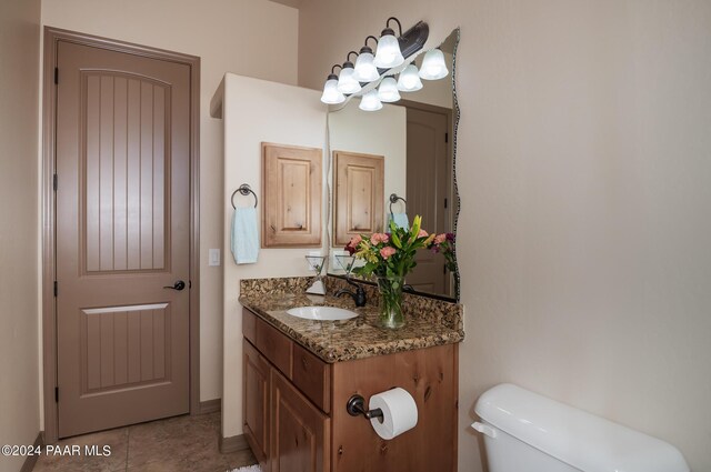 bathroom with tile patterned flooring, vanity, and toilet