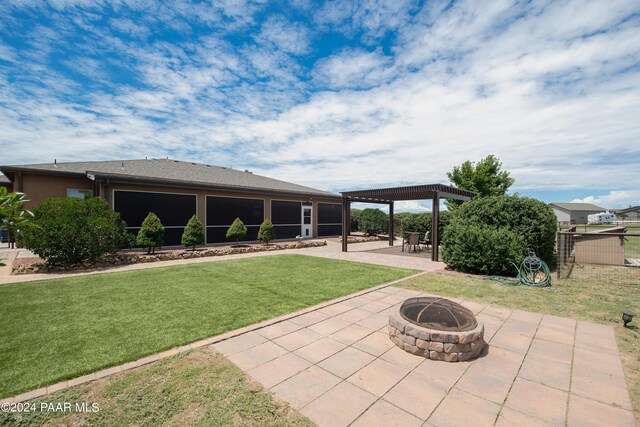 exterior space with a patio, an outdoor fire pit, and a pergola