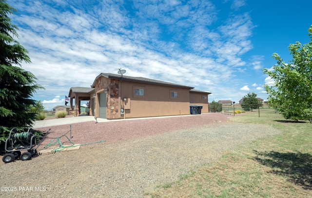 rear view of house with a garage