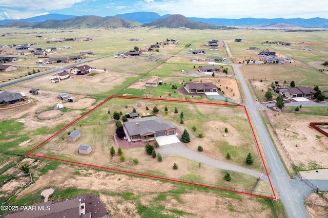 birds eye view of property with a mountain view and a rural view