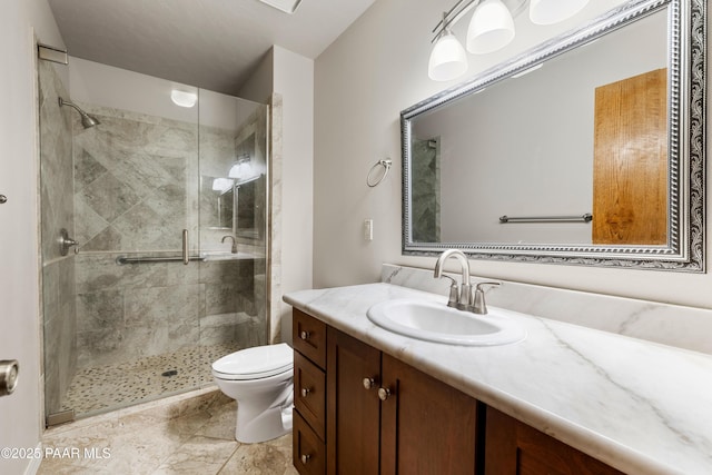 bathroom with a shower stall, toilet, and vanity
