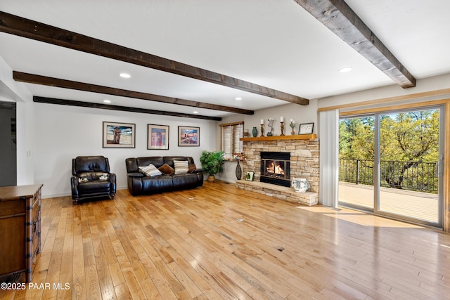 living room with beamed ceiling, a stone fireplace, hardwood / wood-style flooring, and recessed lighting