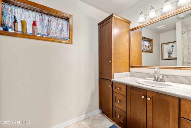 bathroom with baseboards and vanity