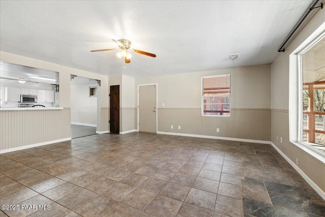 249 S Lynx Creek Rd, Prescott, AZ 86303 - unfurnished living room with a textured ceiling and ceiling fan
