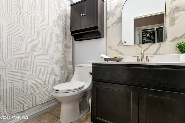 bathroom with toilet, tile patterned flooring, decorative backsplash, and vanity