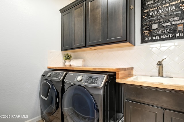 laundry area featuring sink, cabinets, and washer and dryer